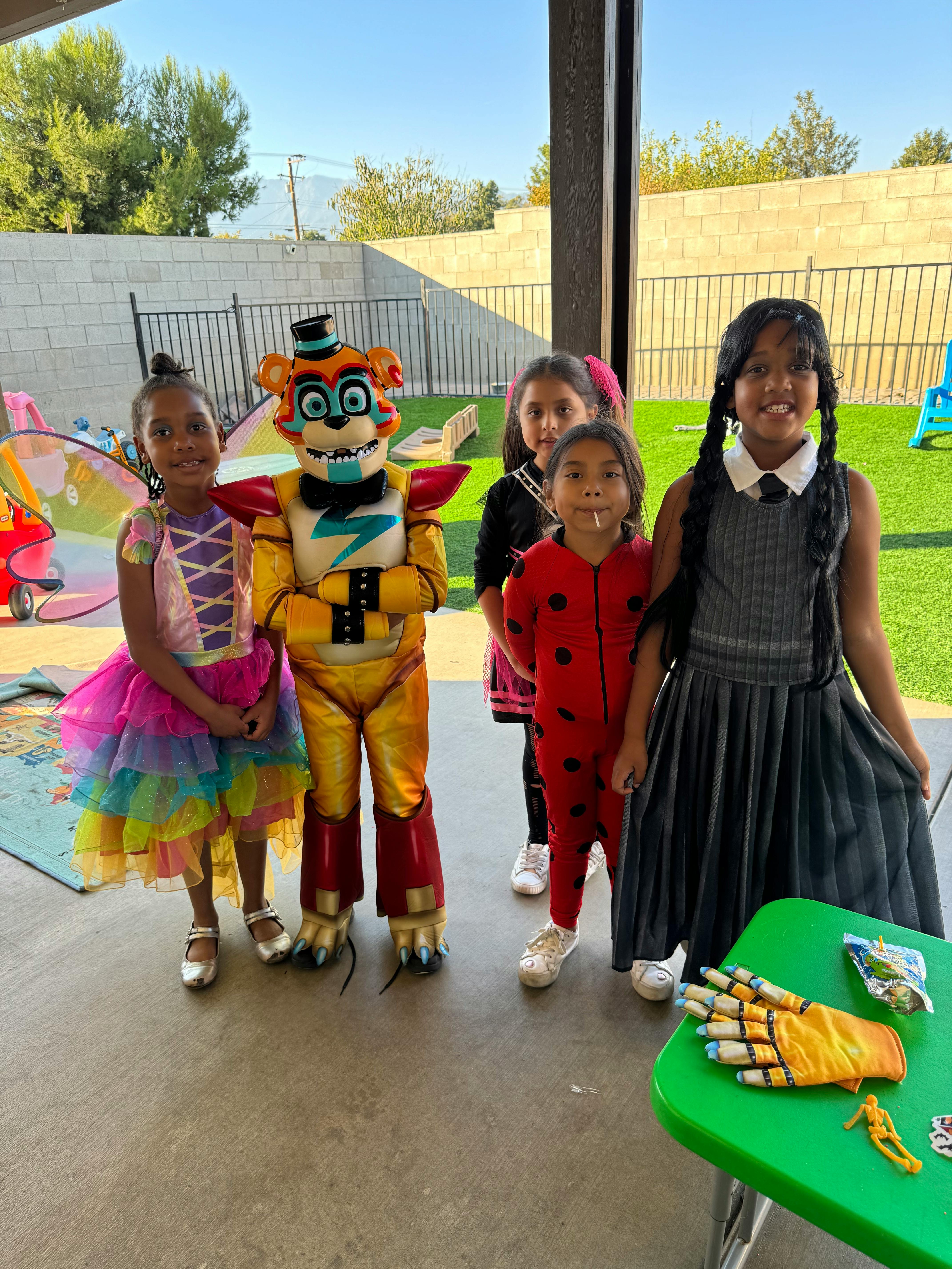 Children in costumes with a person in a mascot costume