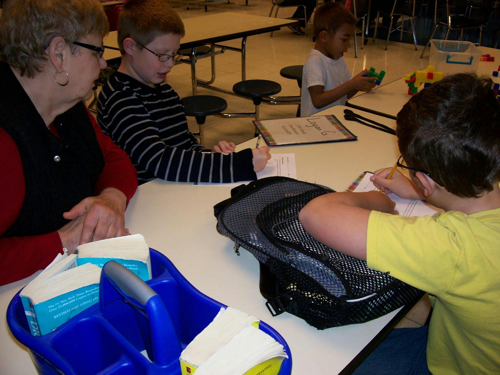 Adult and children at a table in a classroom