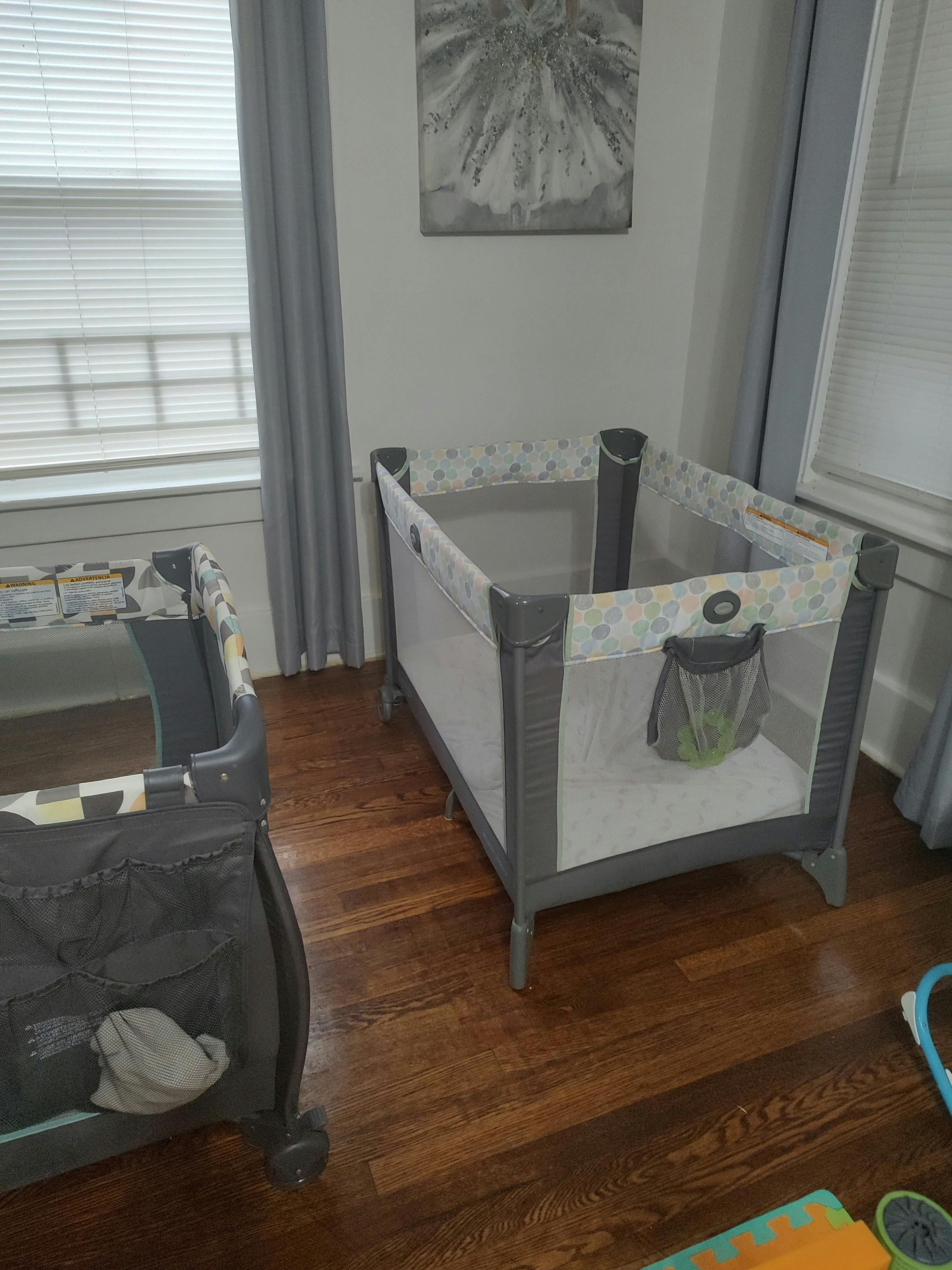 Two portable cribs in a room