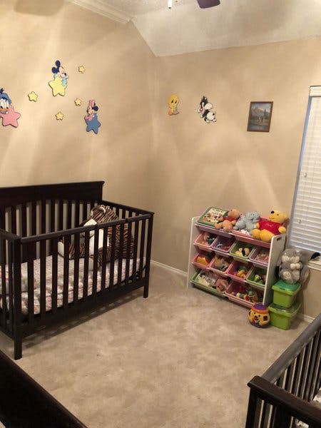 Nursery room with a crib and a toy organizer