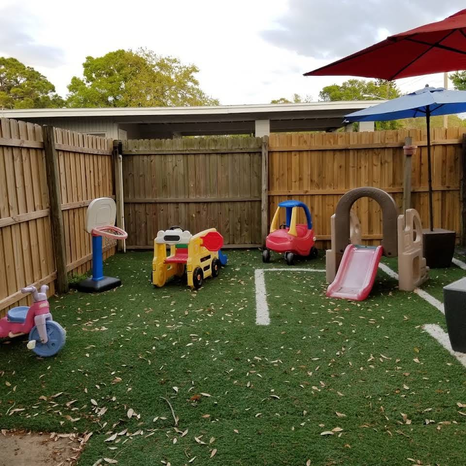 Playground with various play equipment on artificial turf