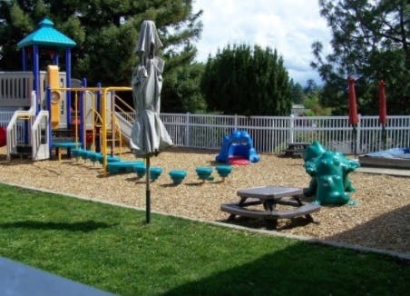 Playground with play structure, slides, and picnic table