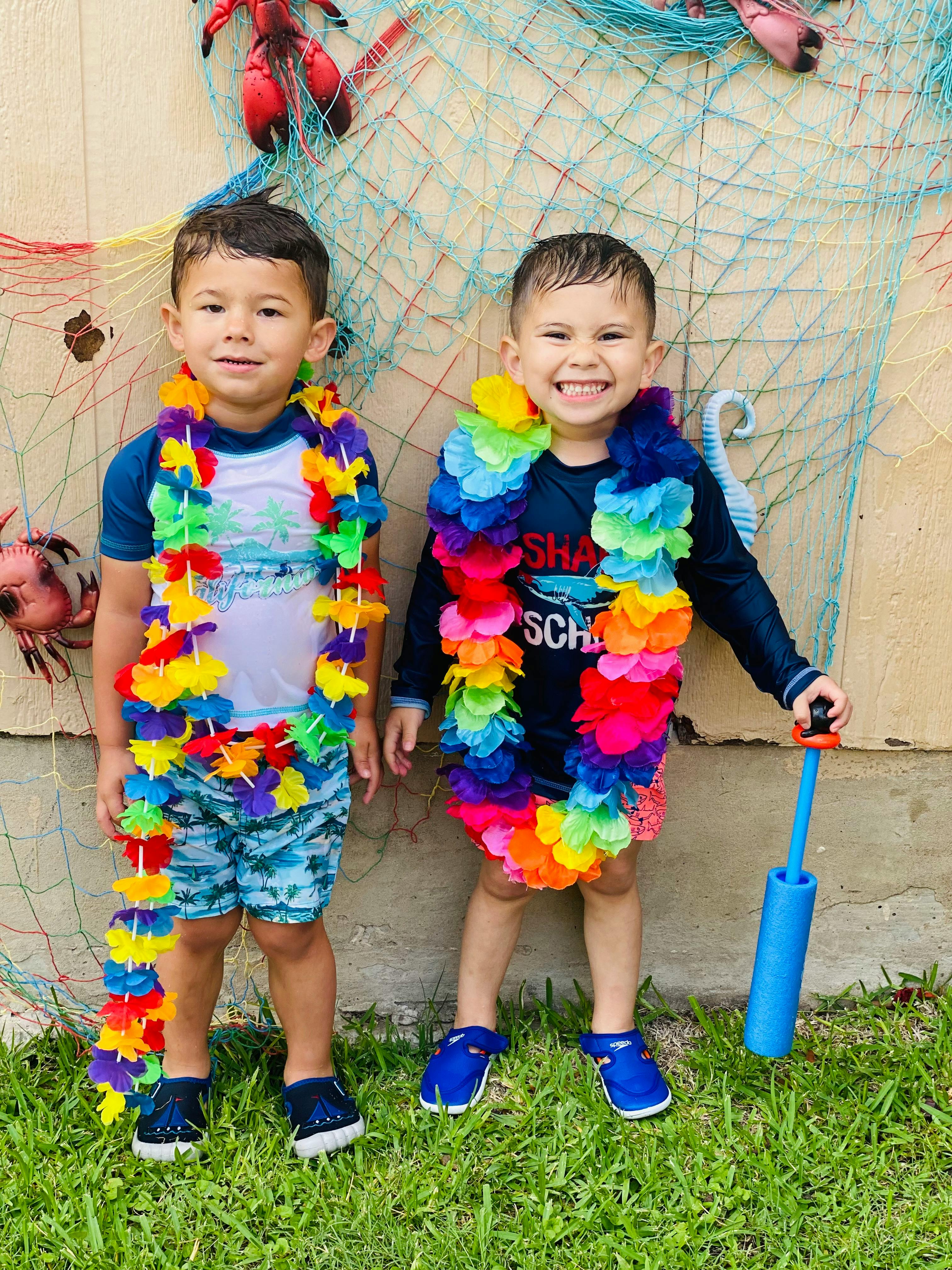 Two children wearing colorful leis