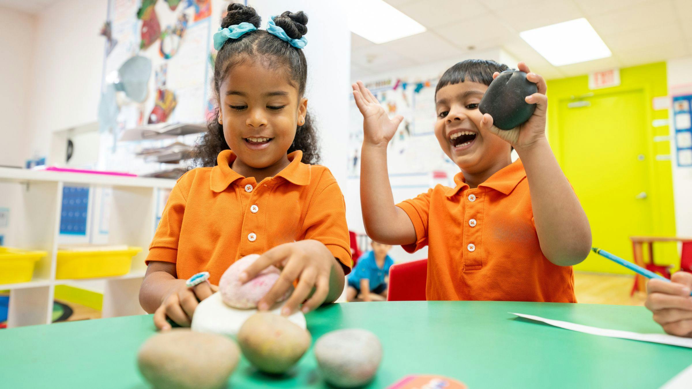 Two children playing with modeling clay at a table