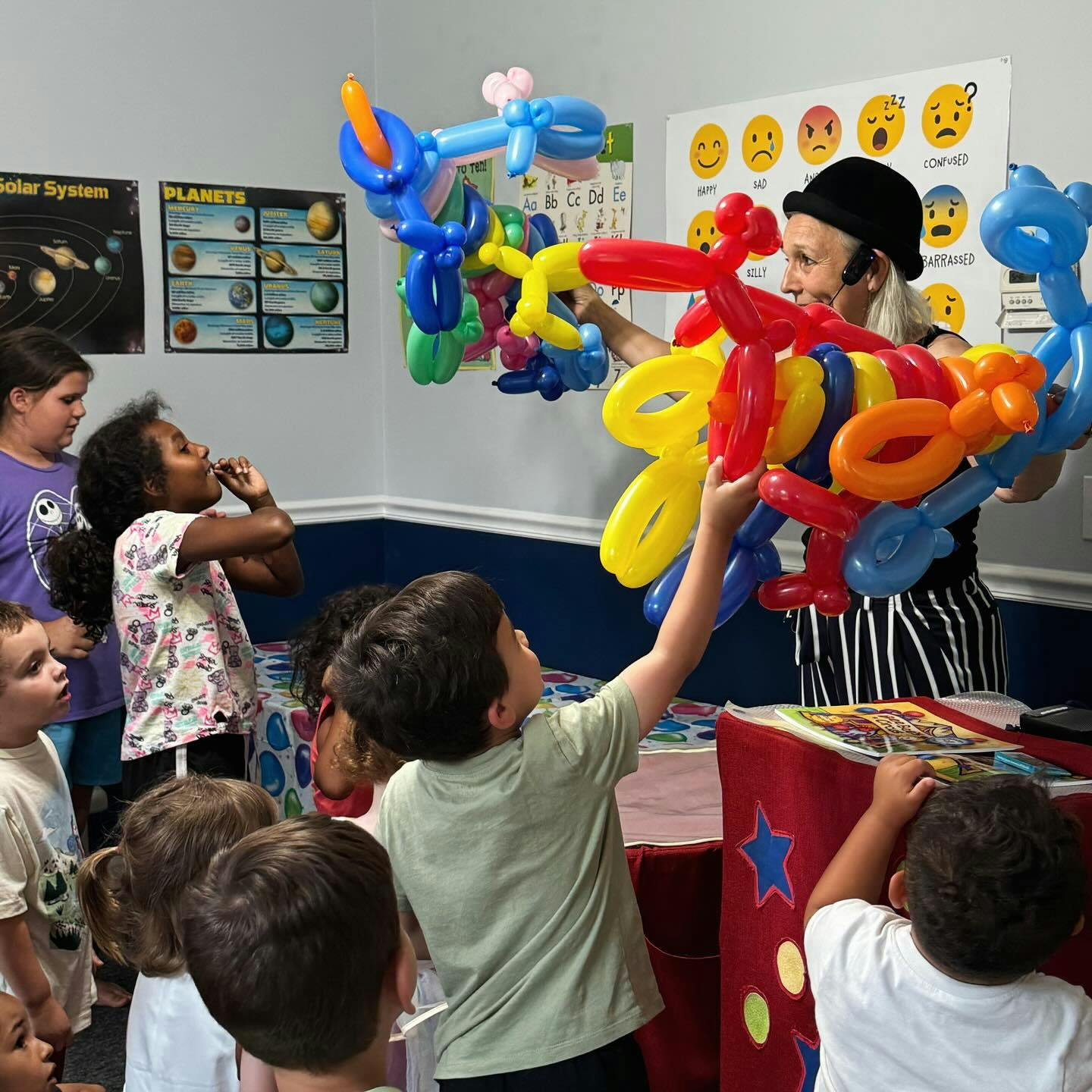Person making balloon animals for children