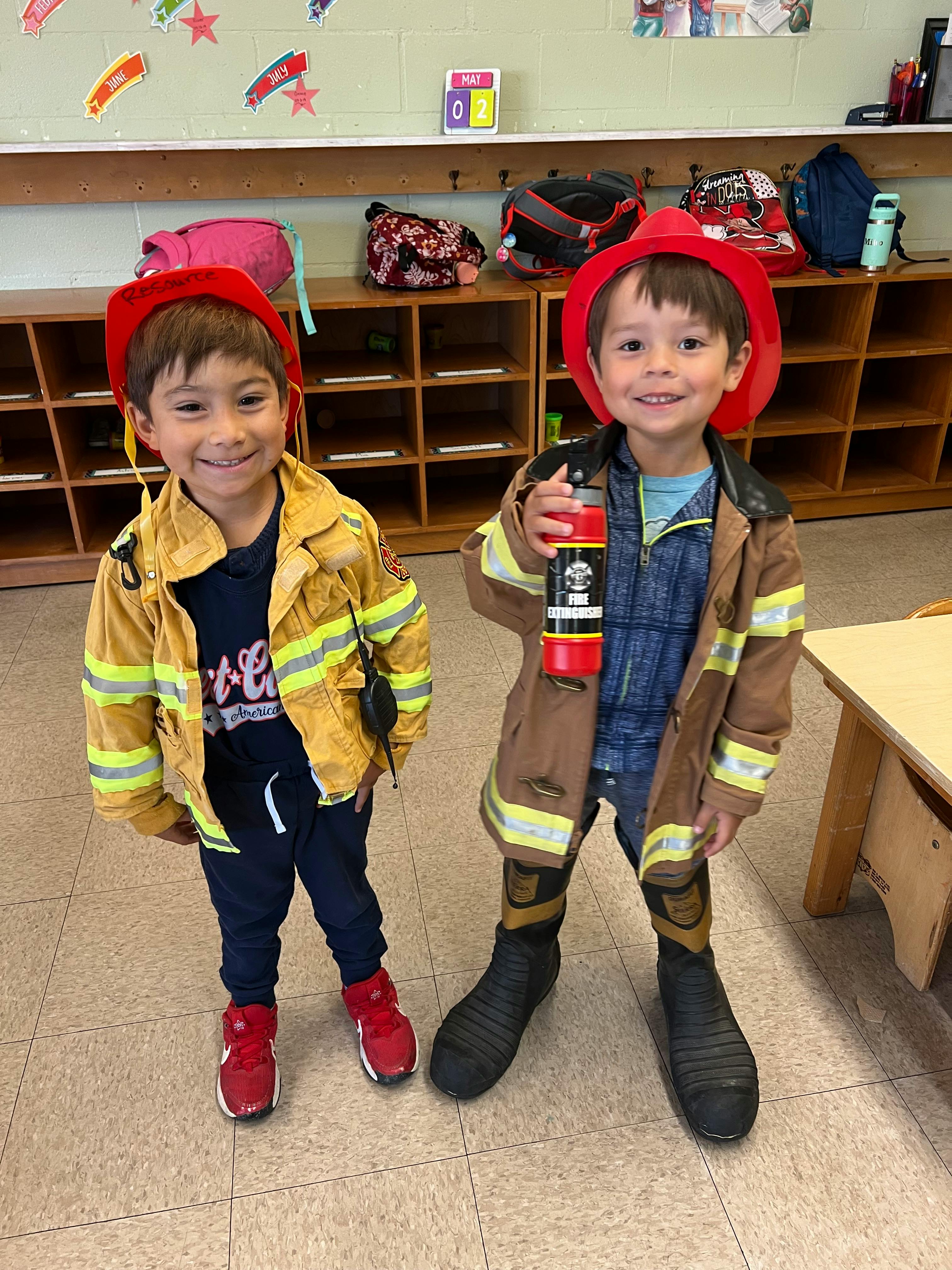 Two children in firefighter costumes