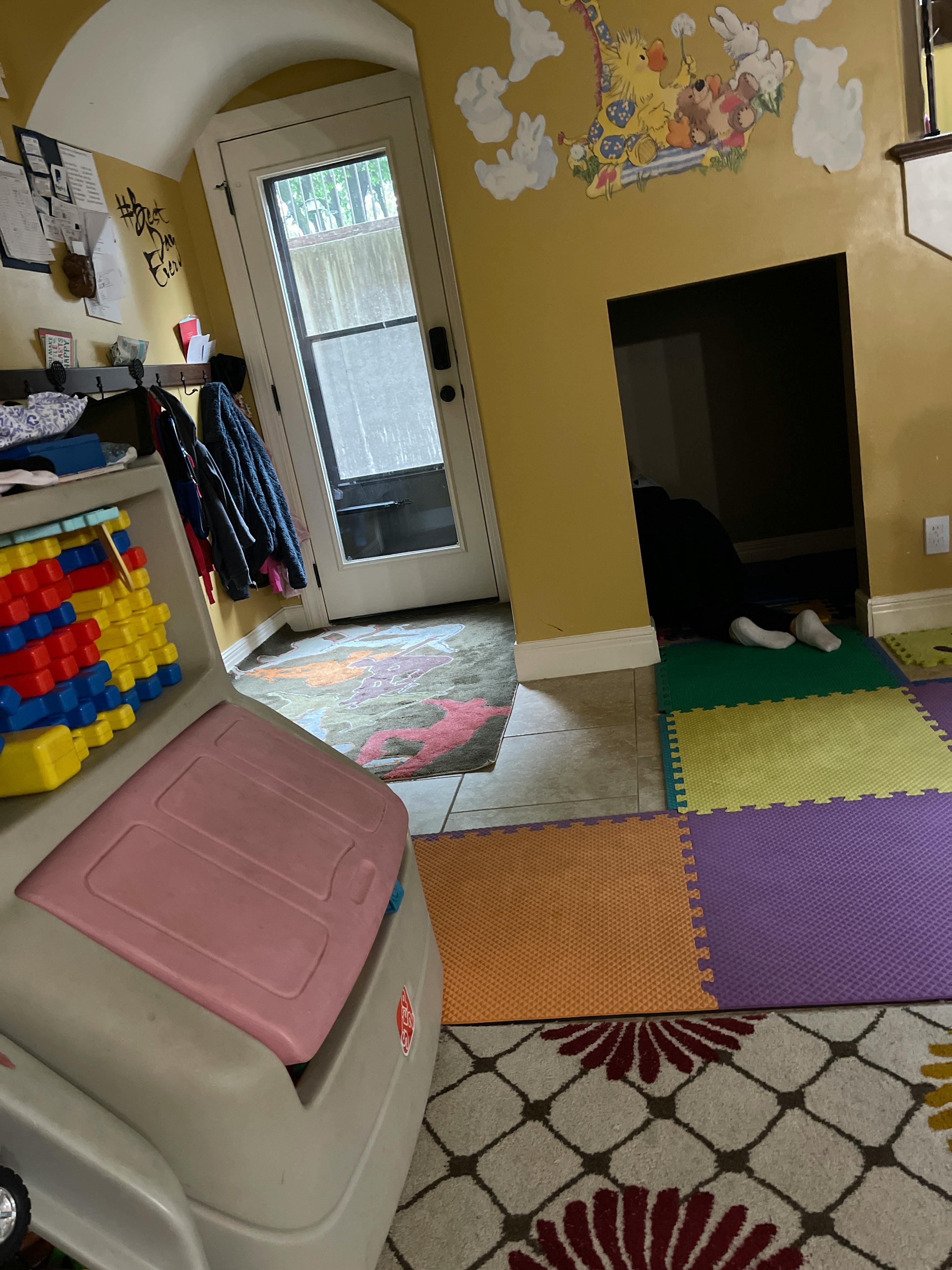 Child crawling into a dark opening in a wall