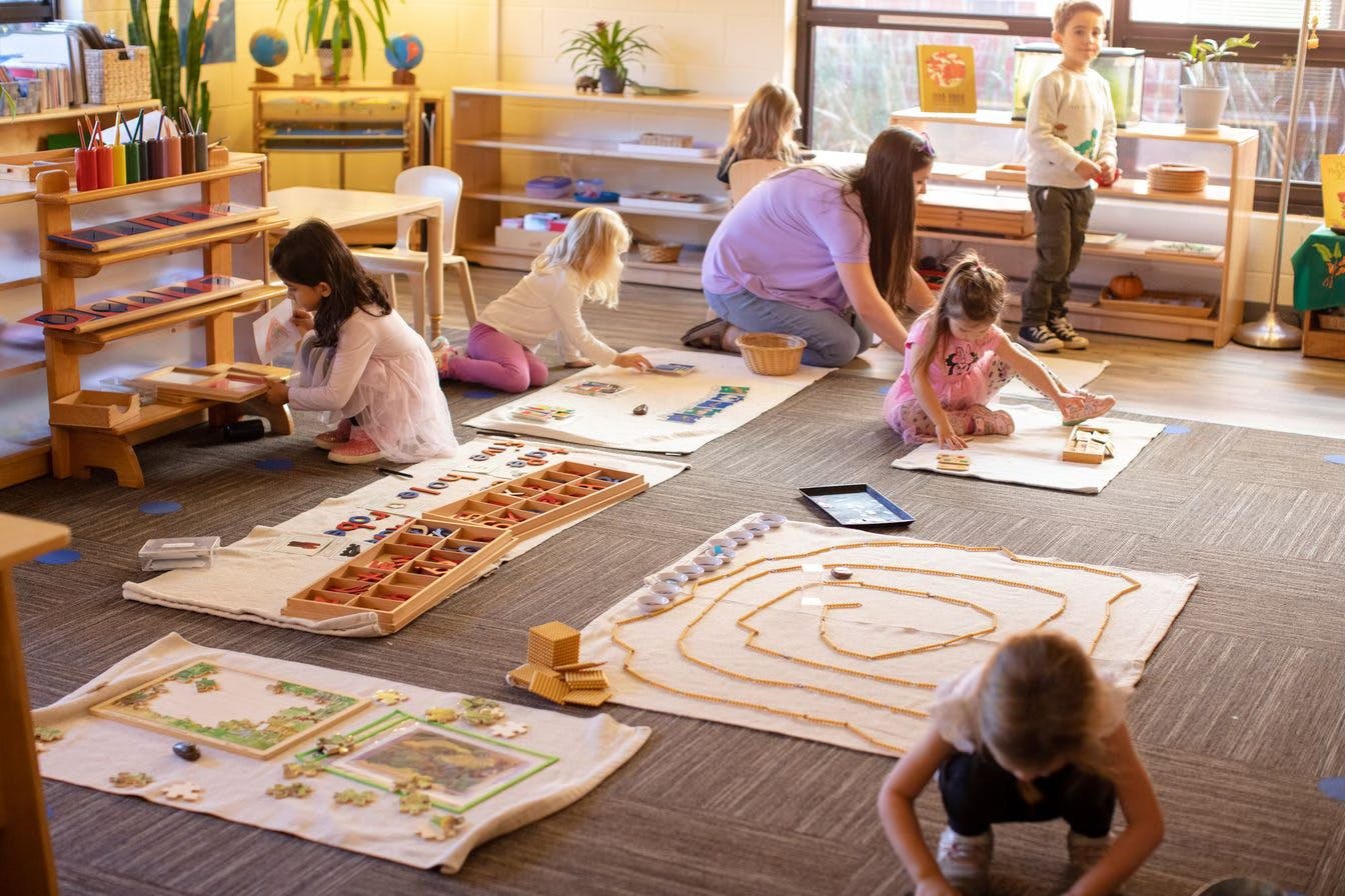 Adults and children engaged in various activities in a classroom