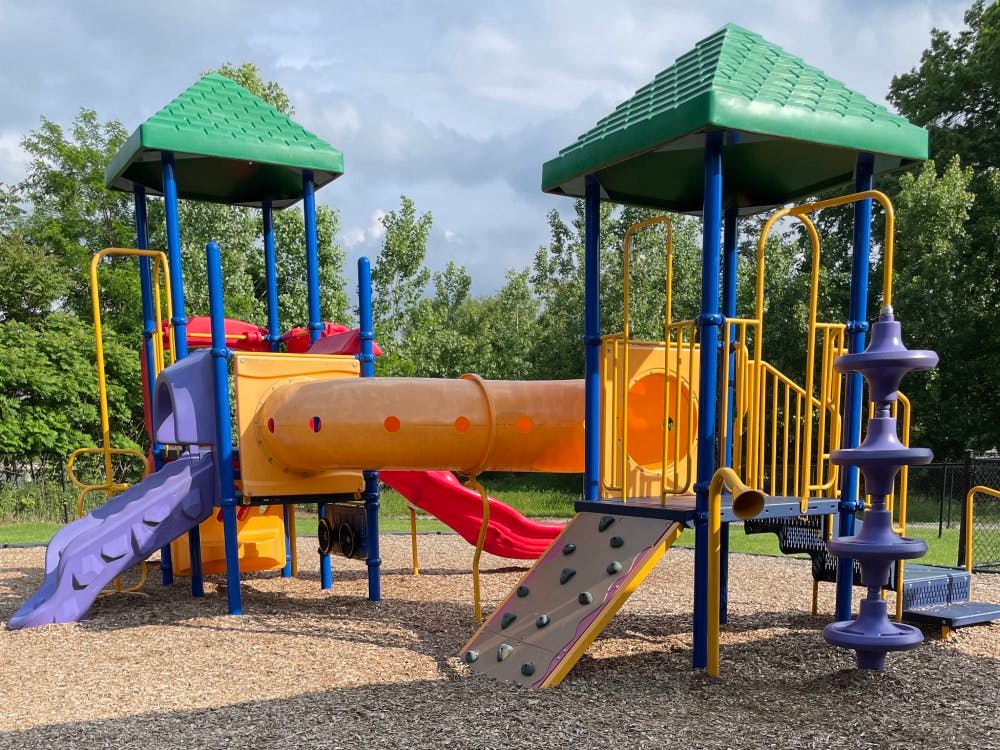 Colorful playground structure with slides, tunnels, and climbing wall