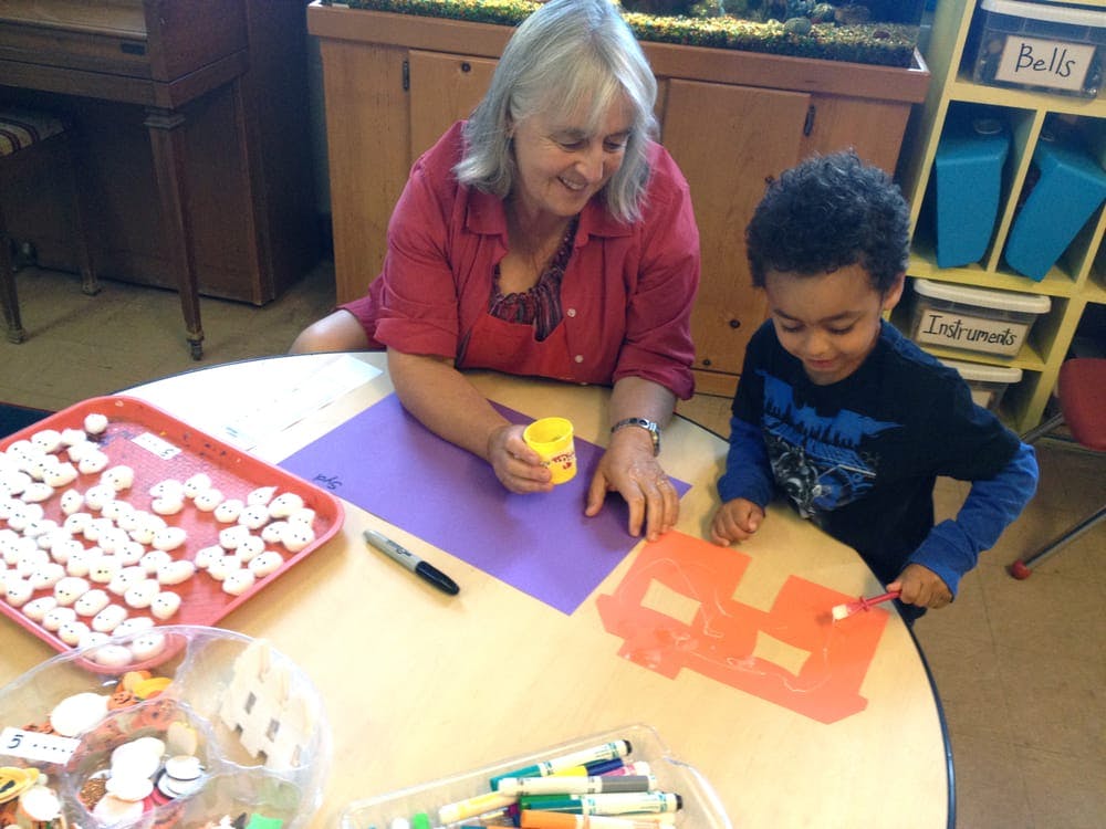 Adult and child doing an art activity at a table