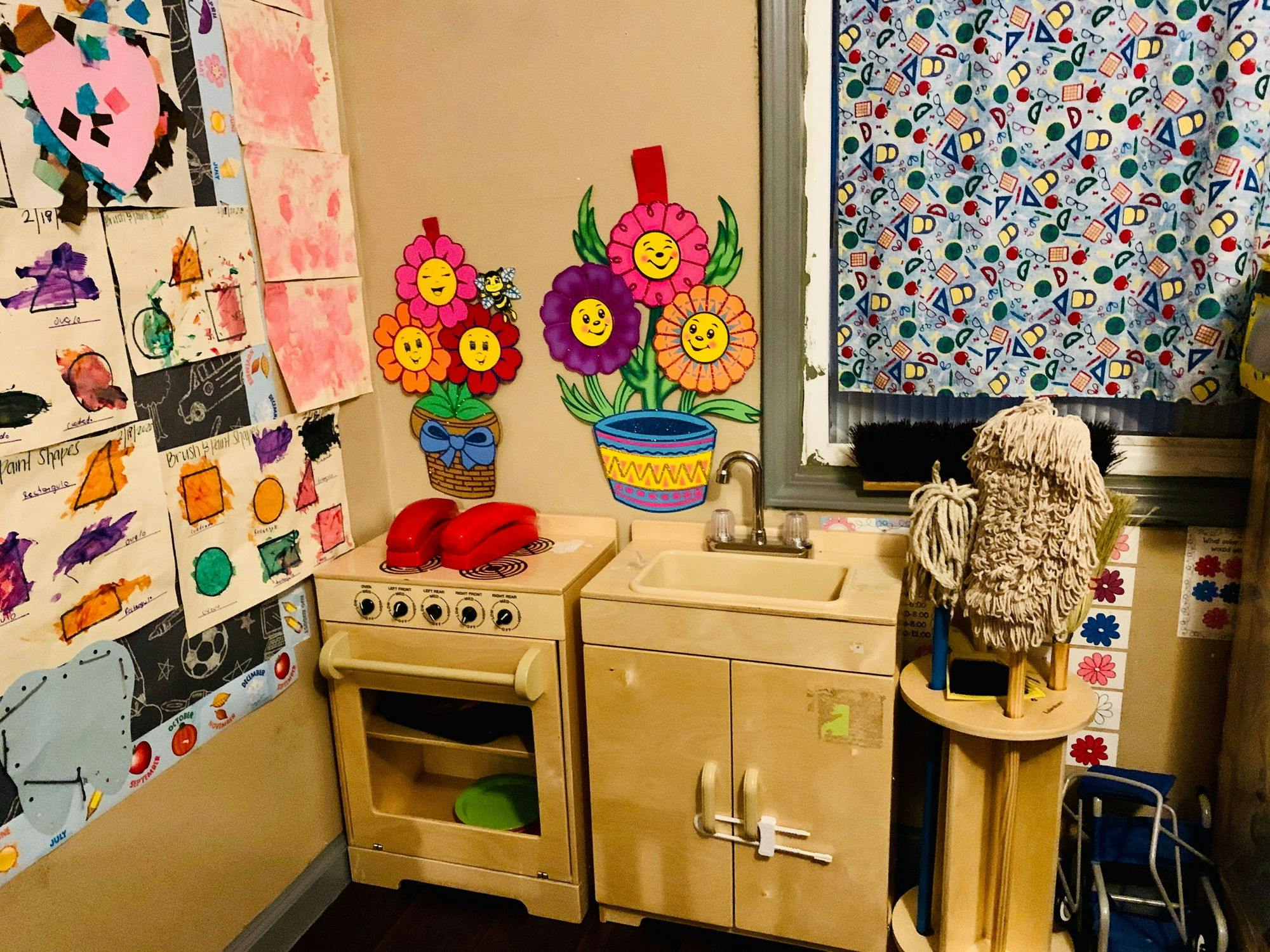 Children's play kitchen with stove and sink, colorful flower decorations