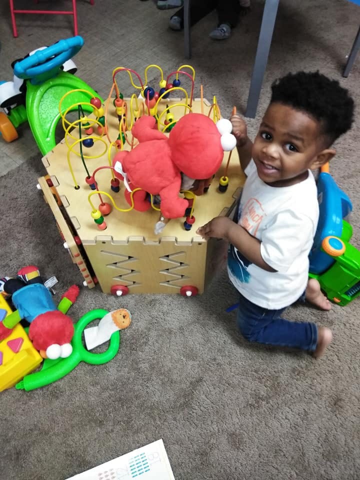 Child playing with a bead maze toy