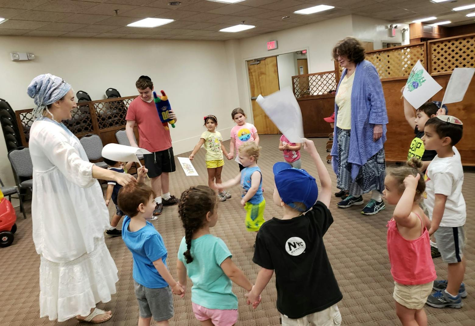 Adults and children holding hands in a circle