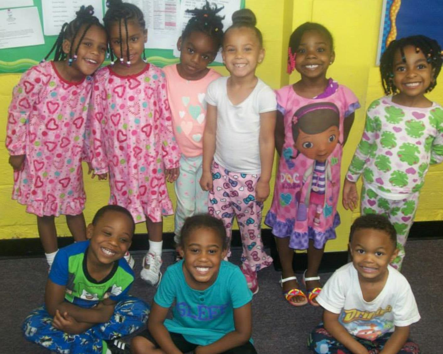 Group of children in pajamas smiling