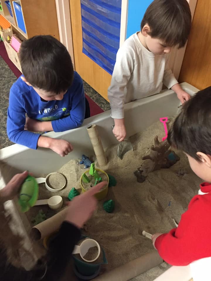 Children playing in a sand table