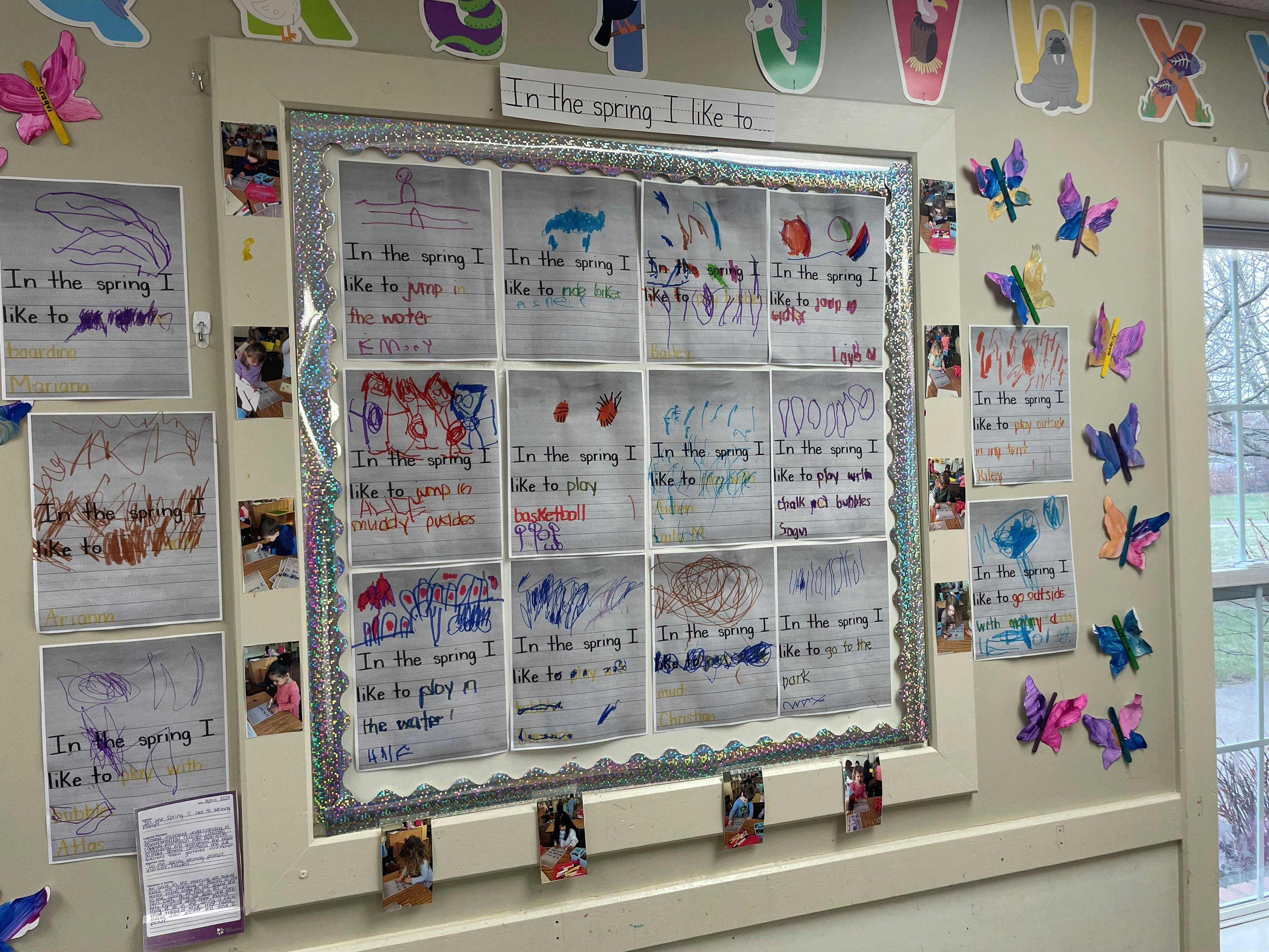 Classroom bulletin board with children's drawings and "In the spring I like to" writing prompts