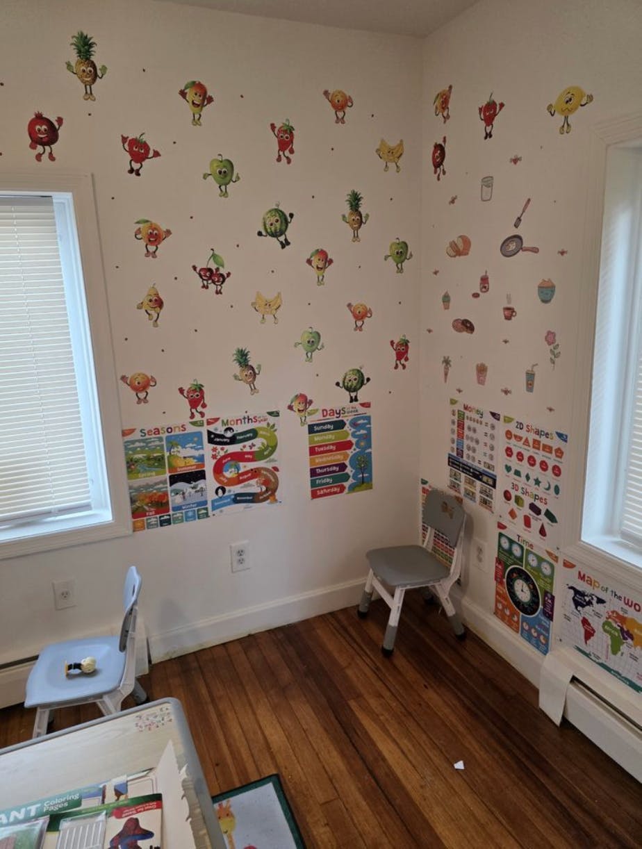 Classroom corner with educational posters and small chairs