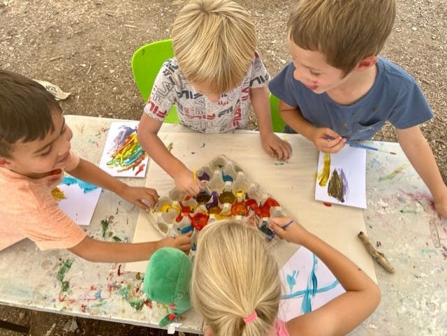Children painting at a table