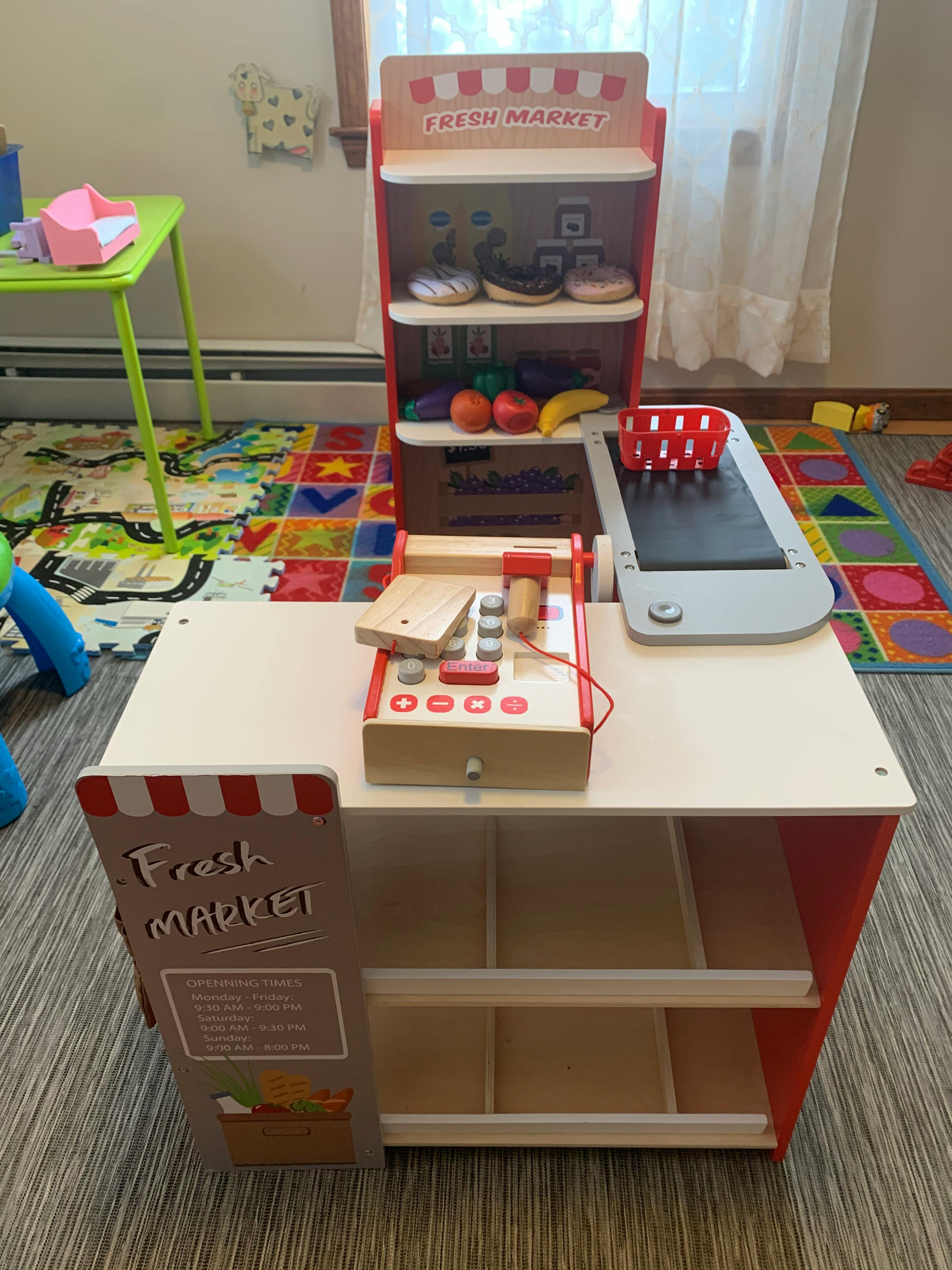 Toy market stand with a cash register and play food