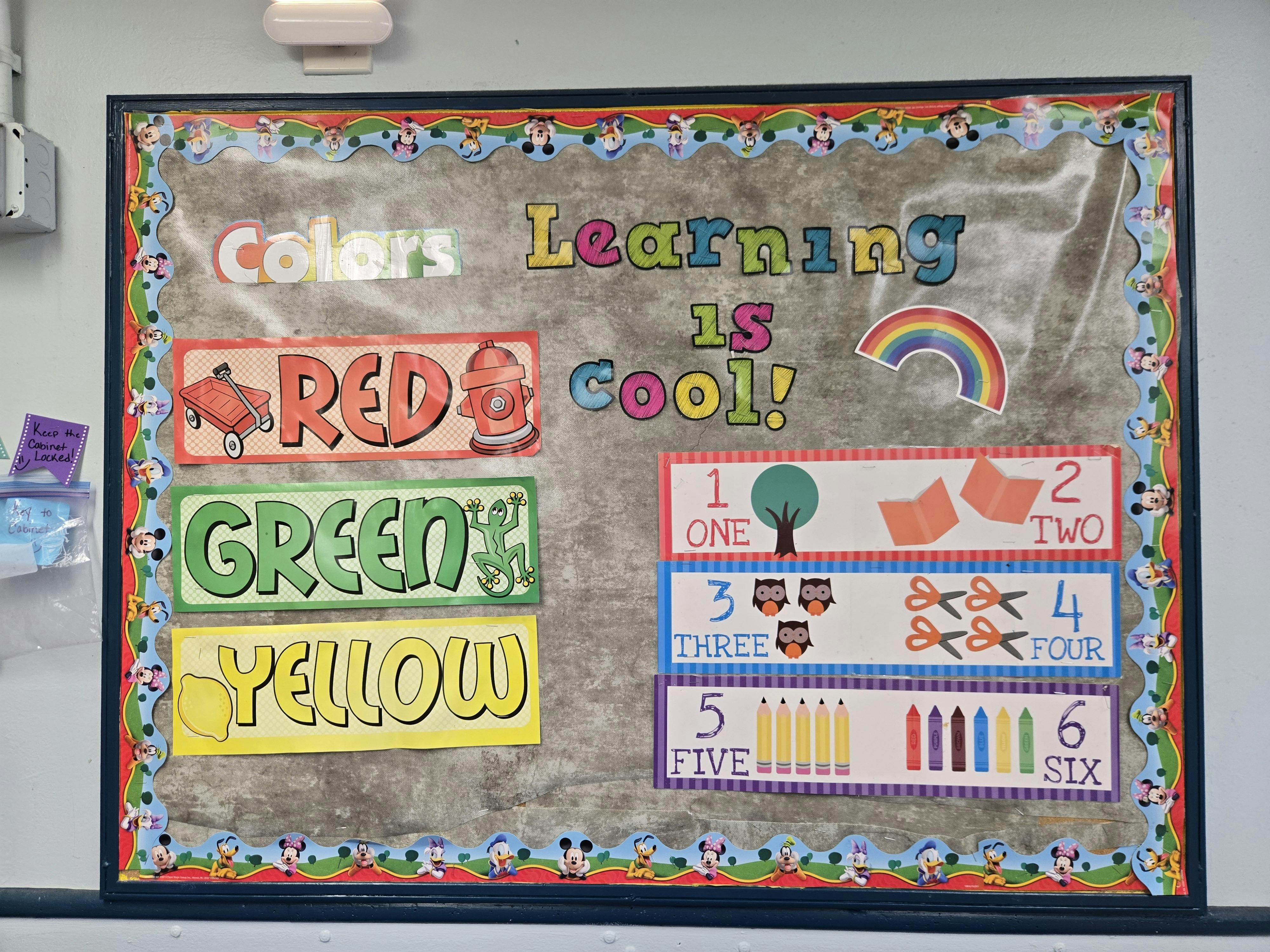 Classroom bulletin board with "Learning is cool!" and color and number charts