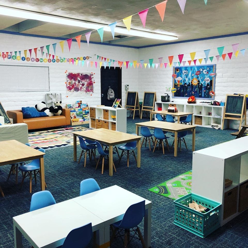 Classroom with tables, chairs, and colorful decorations