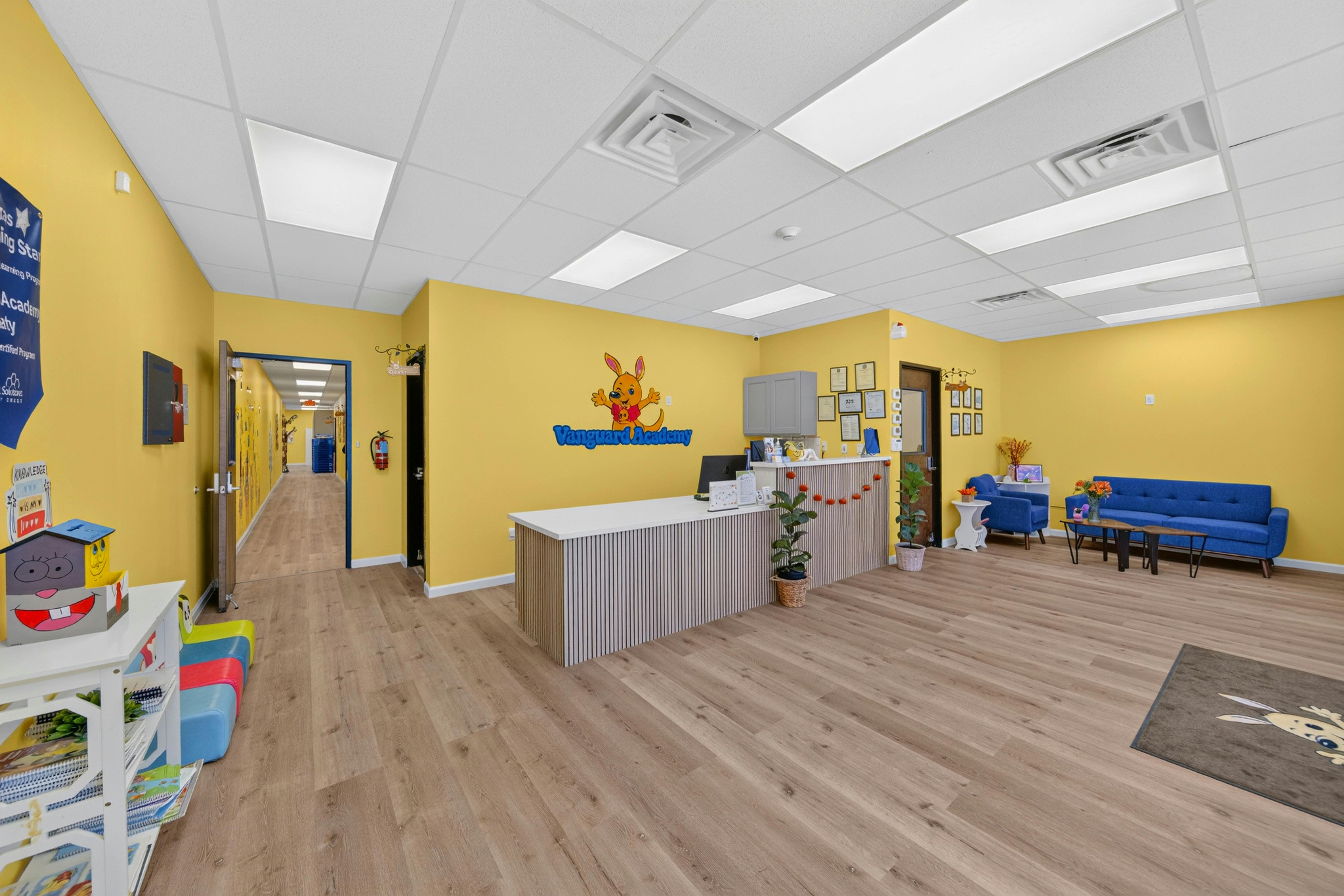 Reception area of Vanguard Academy with front desk and blue seating