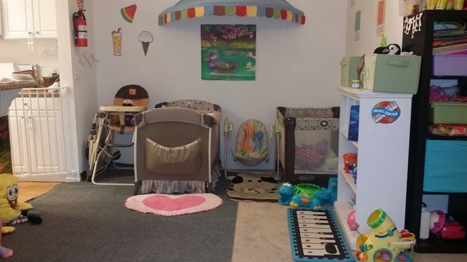 Playroom with cribs, high chair, and toys