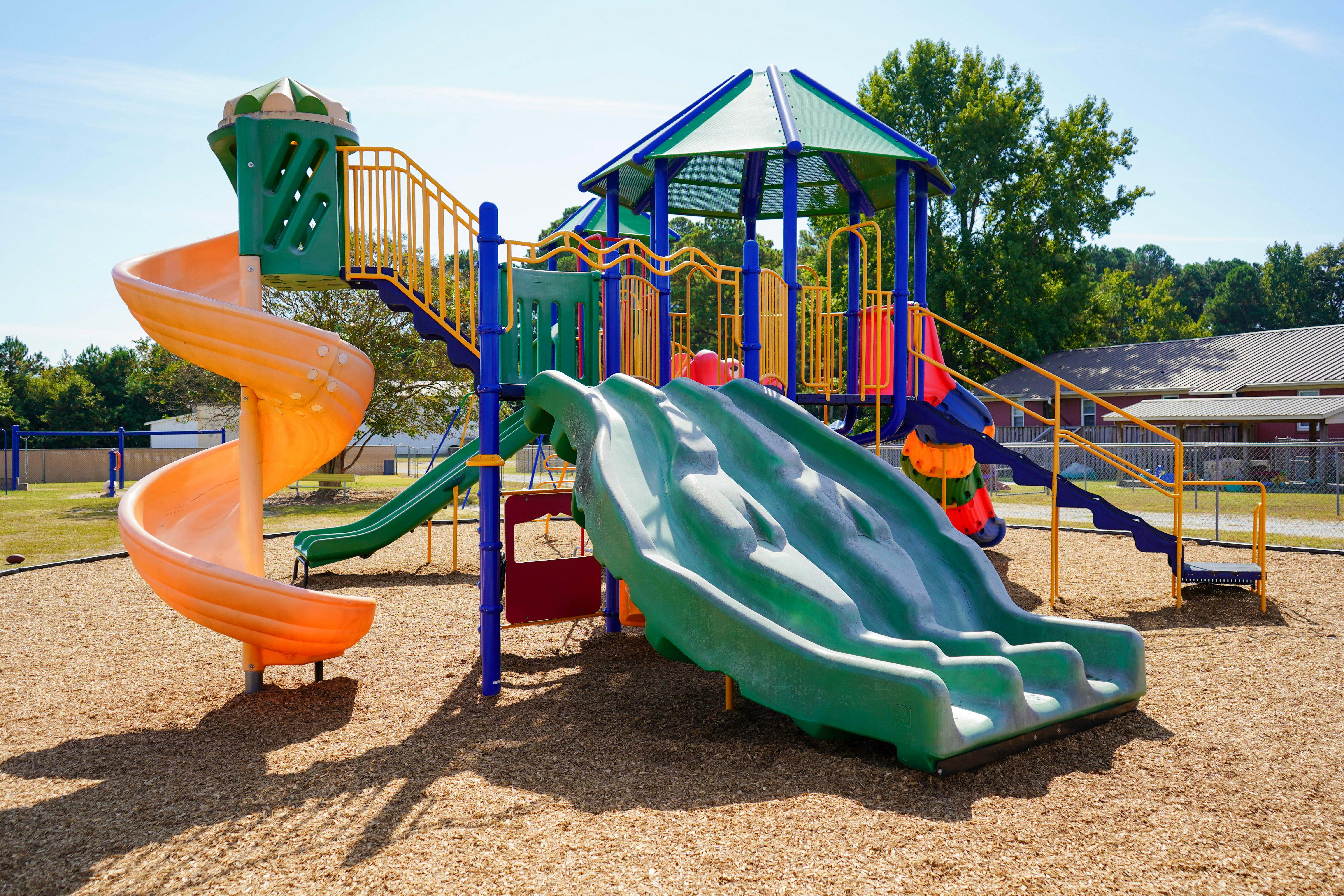 Playground with multiple slides and climbing structures