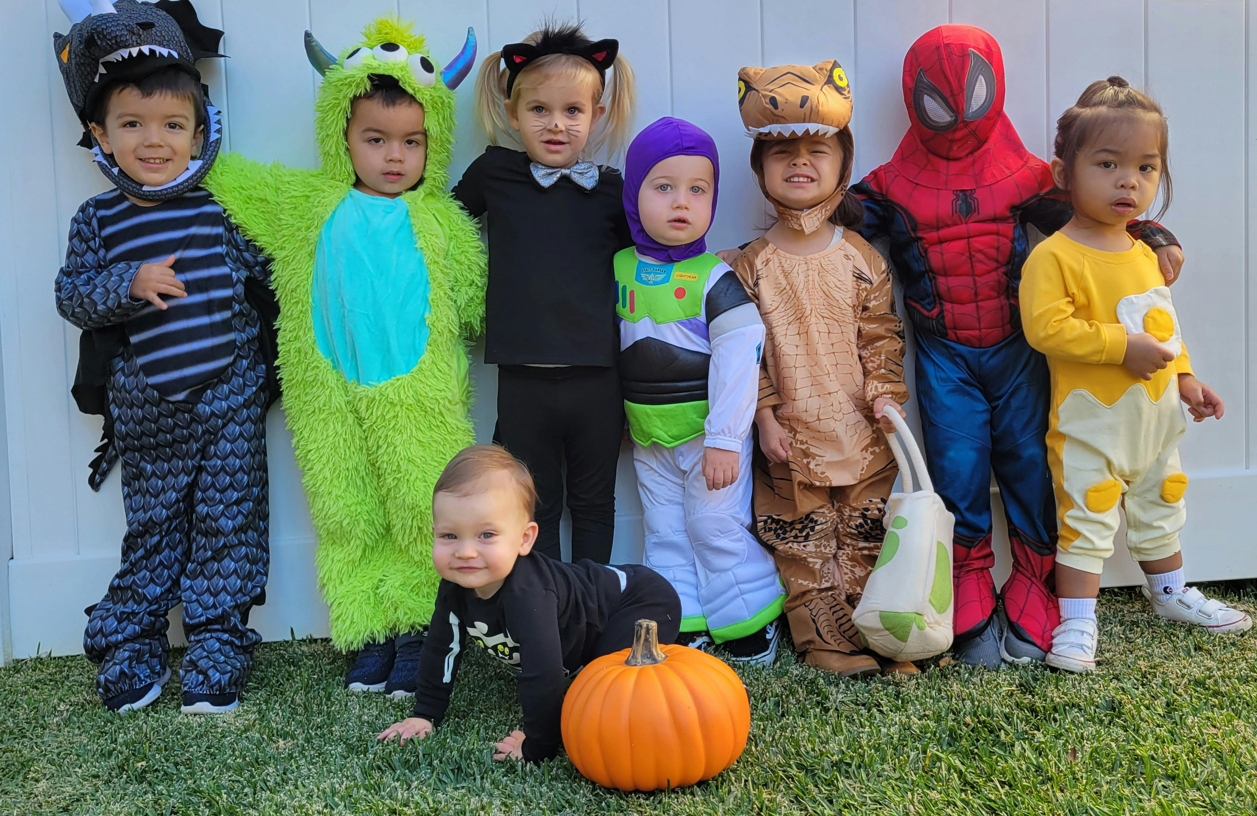Children in various costumes with a pumpkin