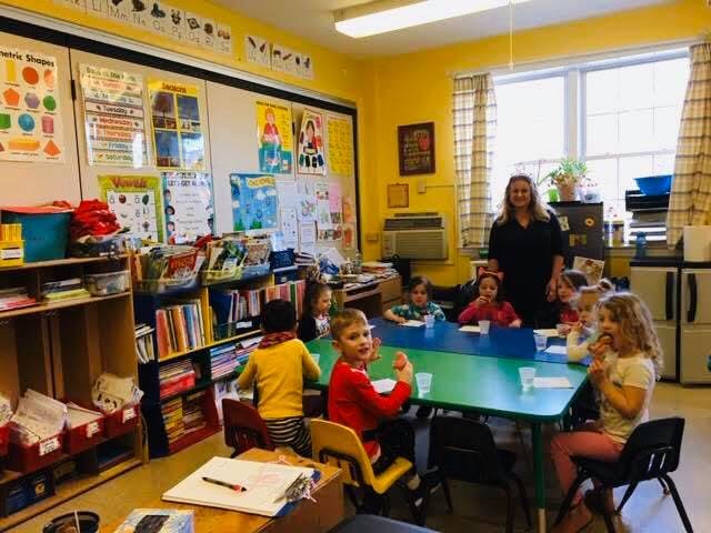 Adult and children in a classroom