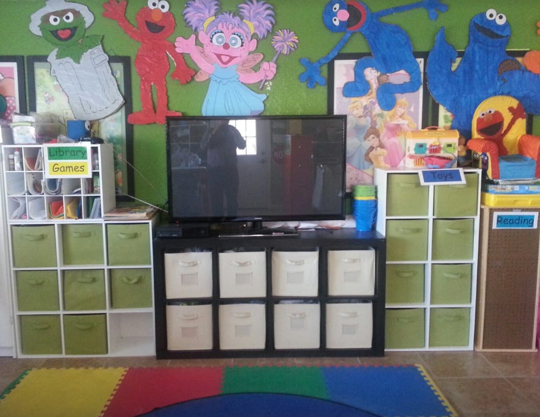 Television on a stand with storage bins in a classroom
