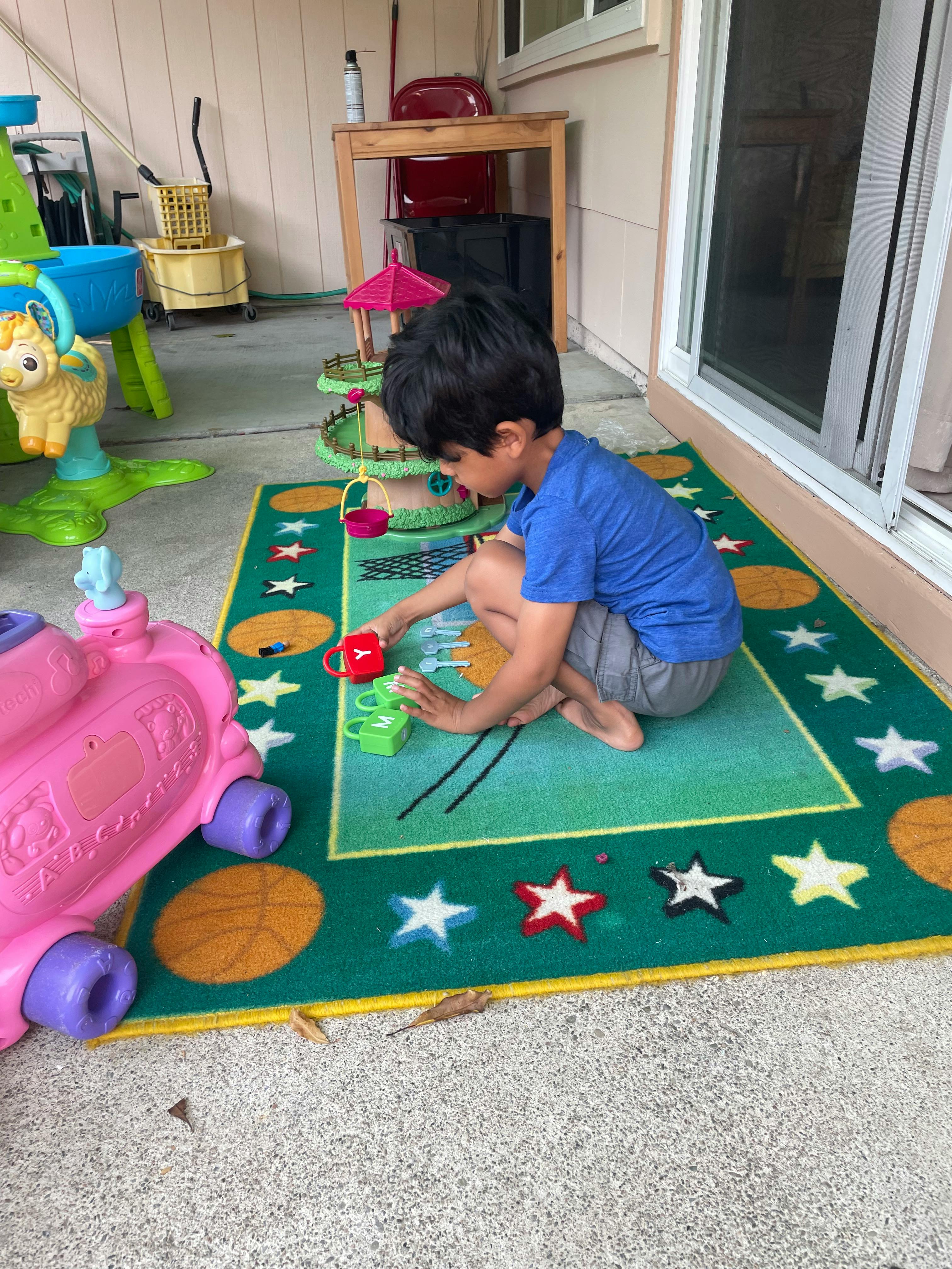 Child playing with toys on a rug