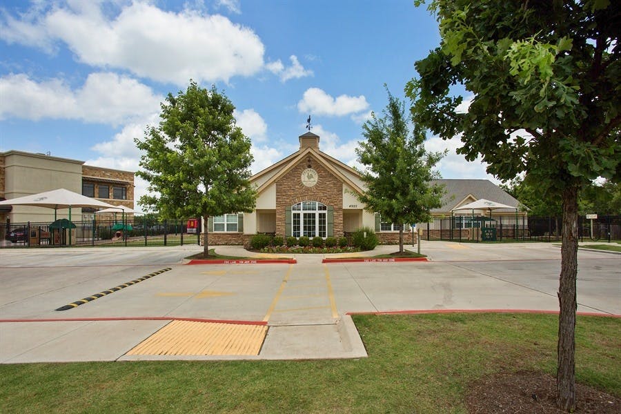 Building with a brick facade and a parking lot in front