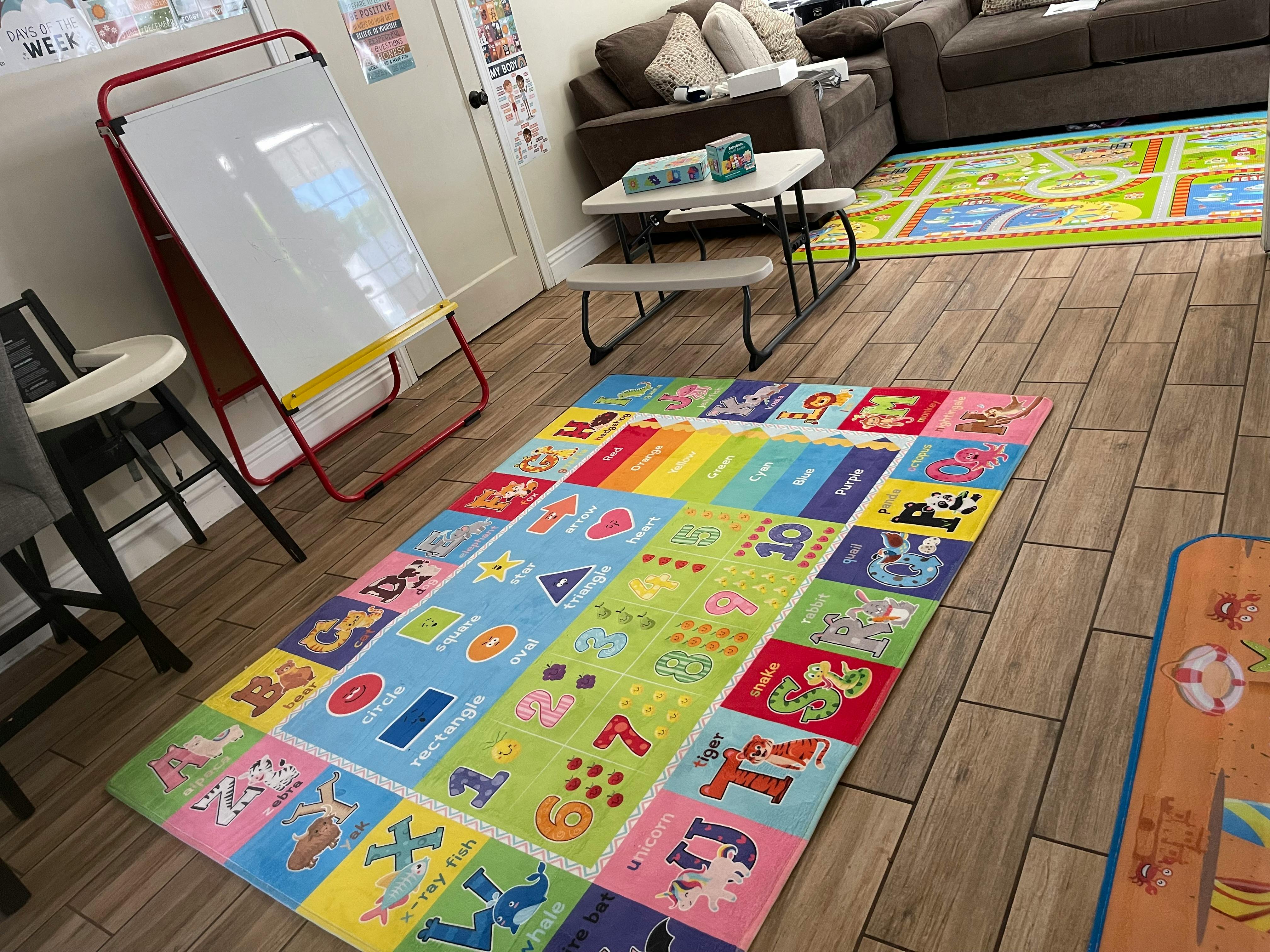 Colorful alphabet and number playmat on a wooden floor