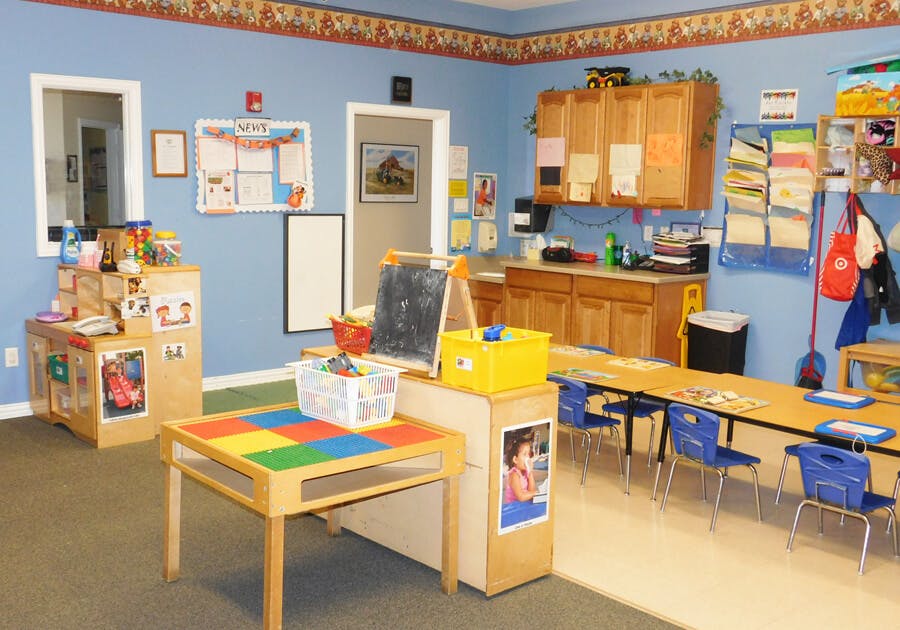 Classroom with tables, chairs, and learning materials