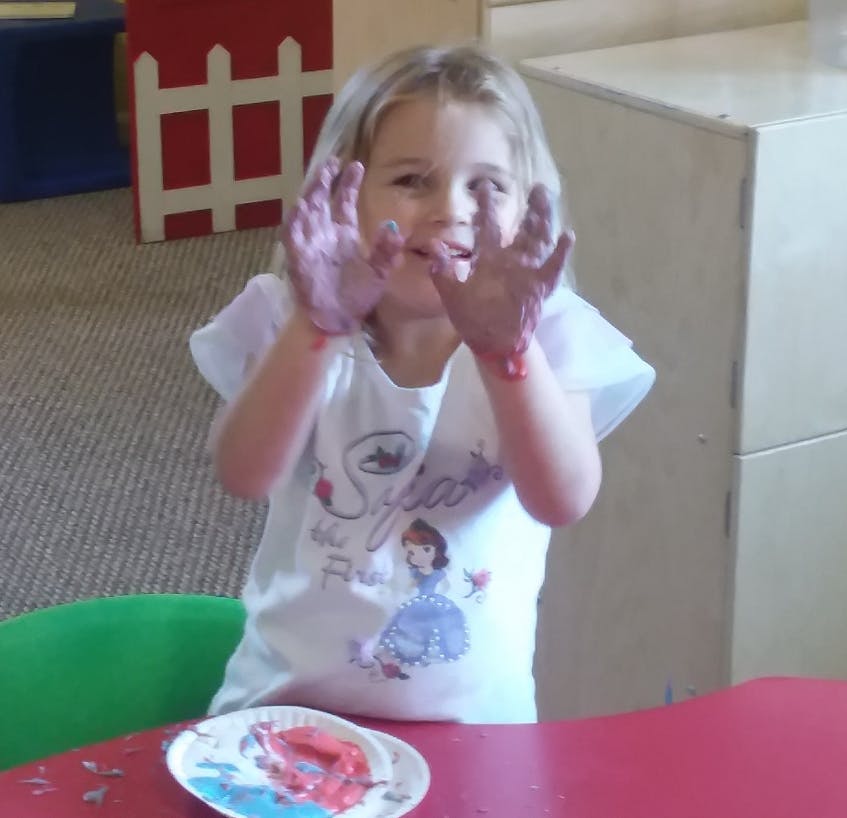 Child with paint on hands