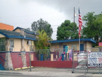 Building with a playground and an American flag