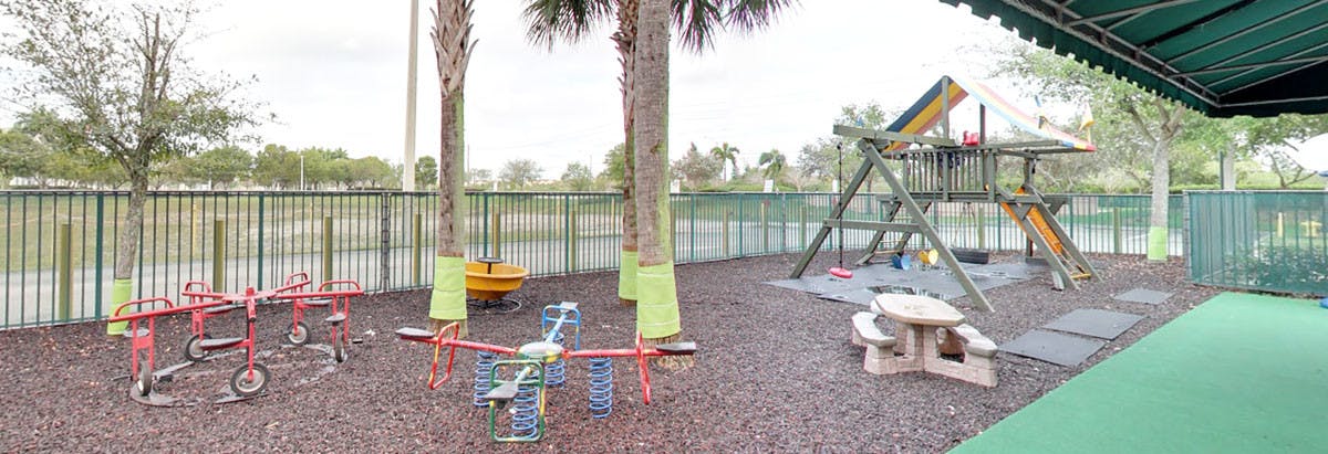 Playground with swings, slides, and a picnic table