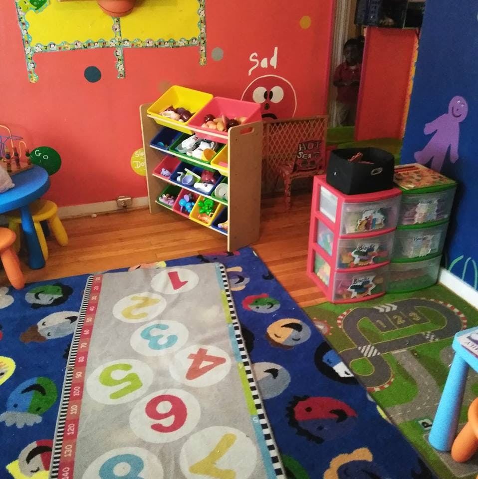 Playroom with toy storage, colorful rugs, and a small table