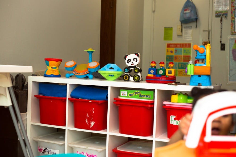Shelf with various toys and red bins