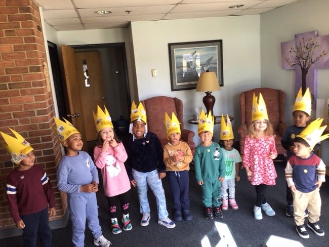 Group of children wearing yellow paper crowns