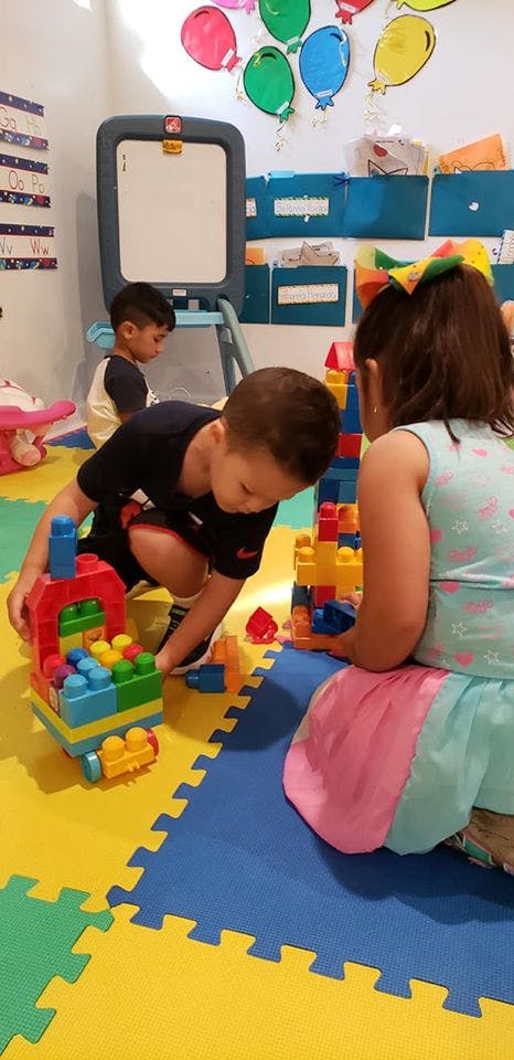 Children playing with building blocks in a classroom