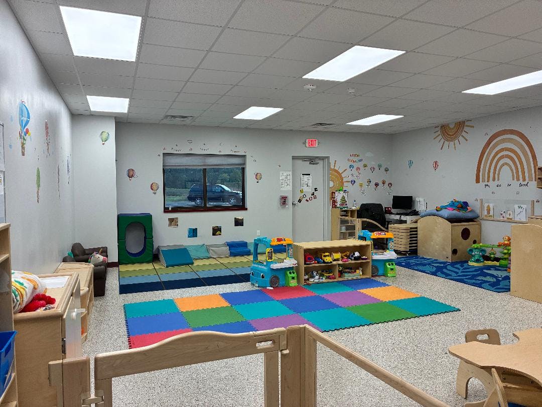 Playroom with colorful floor mats and various toys