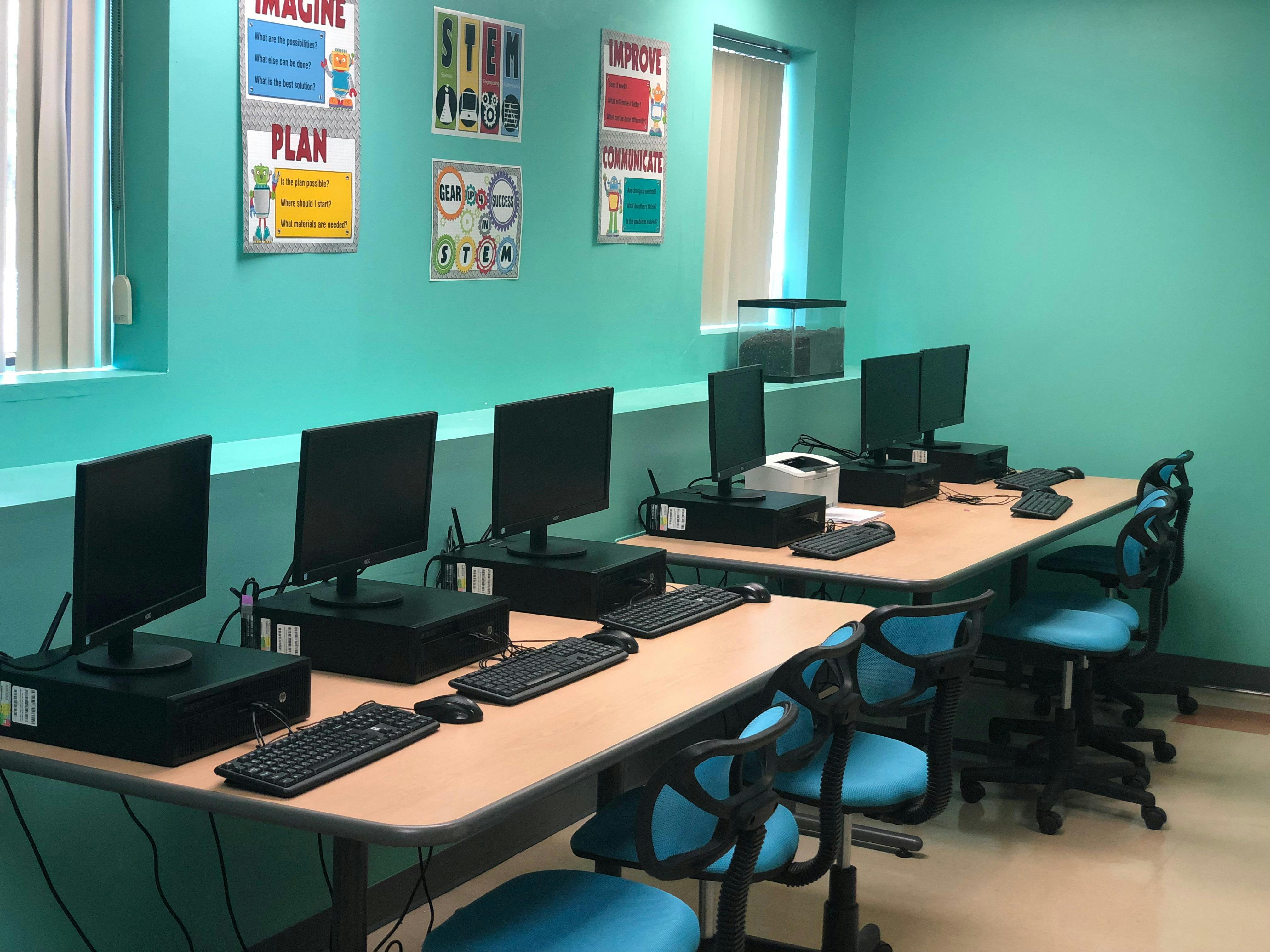 Computer lab with rows of desks, monitors, and keyboards