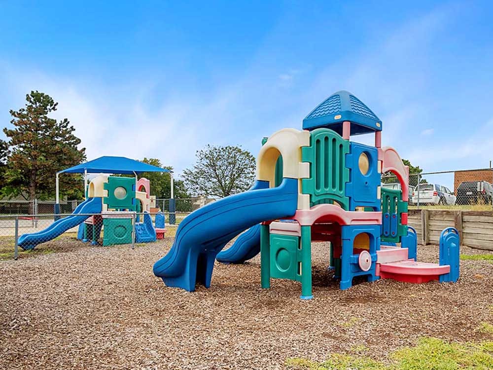 A colorful plastic playground with slides and climbing structures