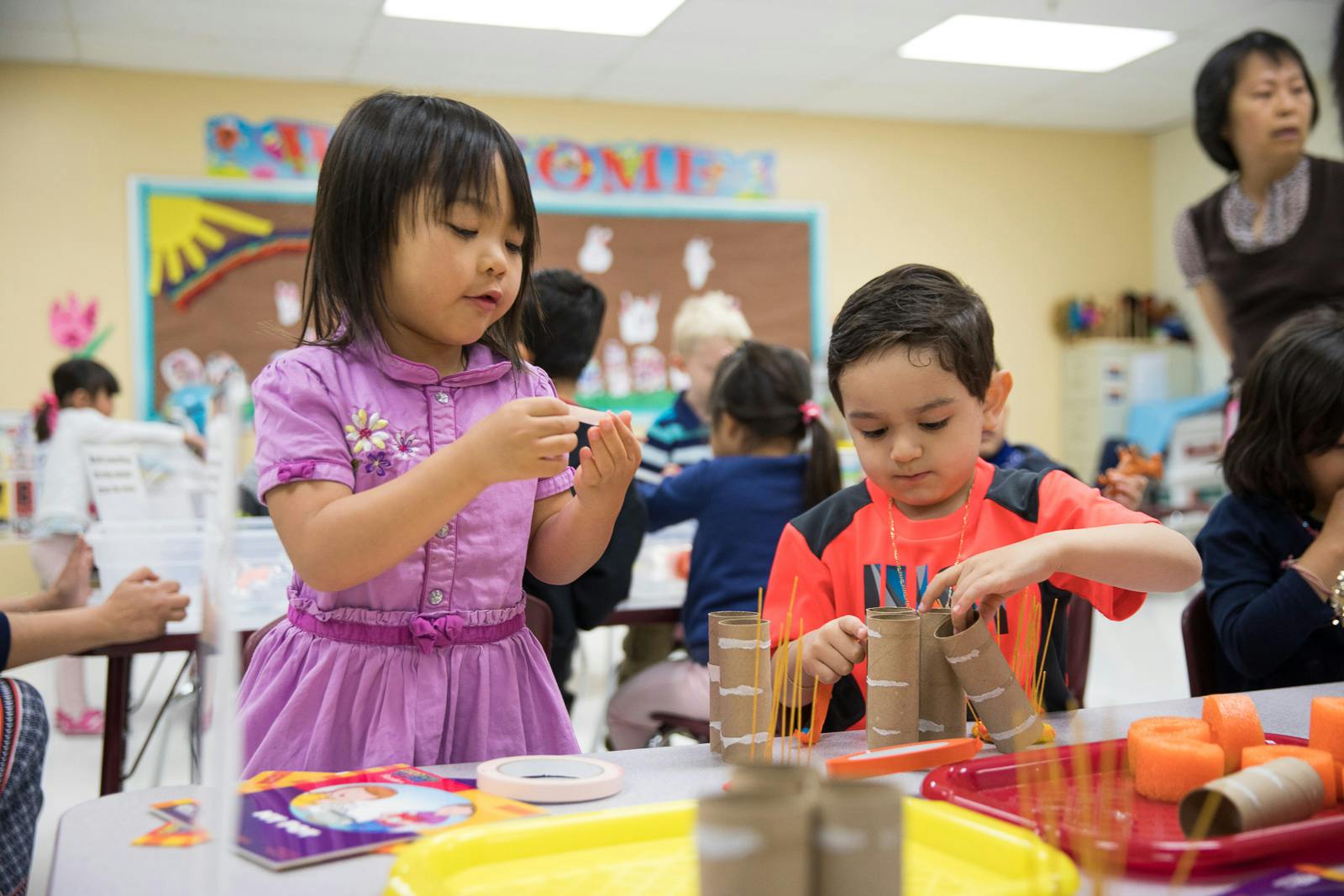 Two children doing crafts at a table