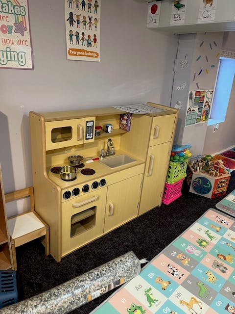 Toy kitchen set with a stove, sink, and refrigerator