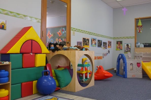Playroom with colorful soft blocks, wooden play cube, and other toys