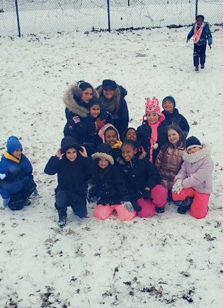 Group of people and children in winter clothing in the snow