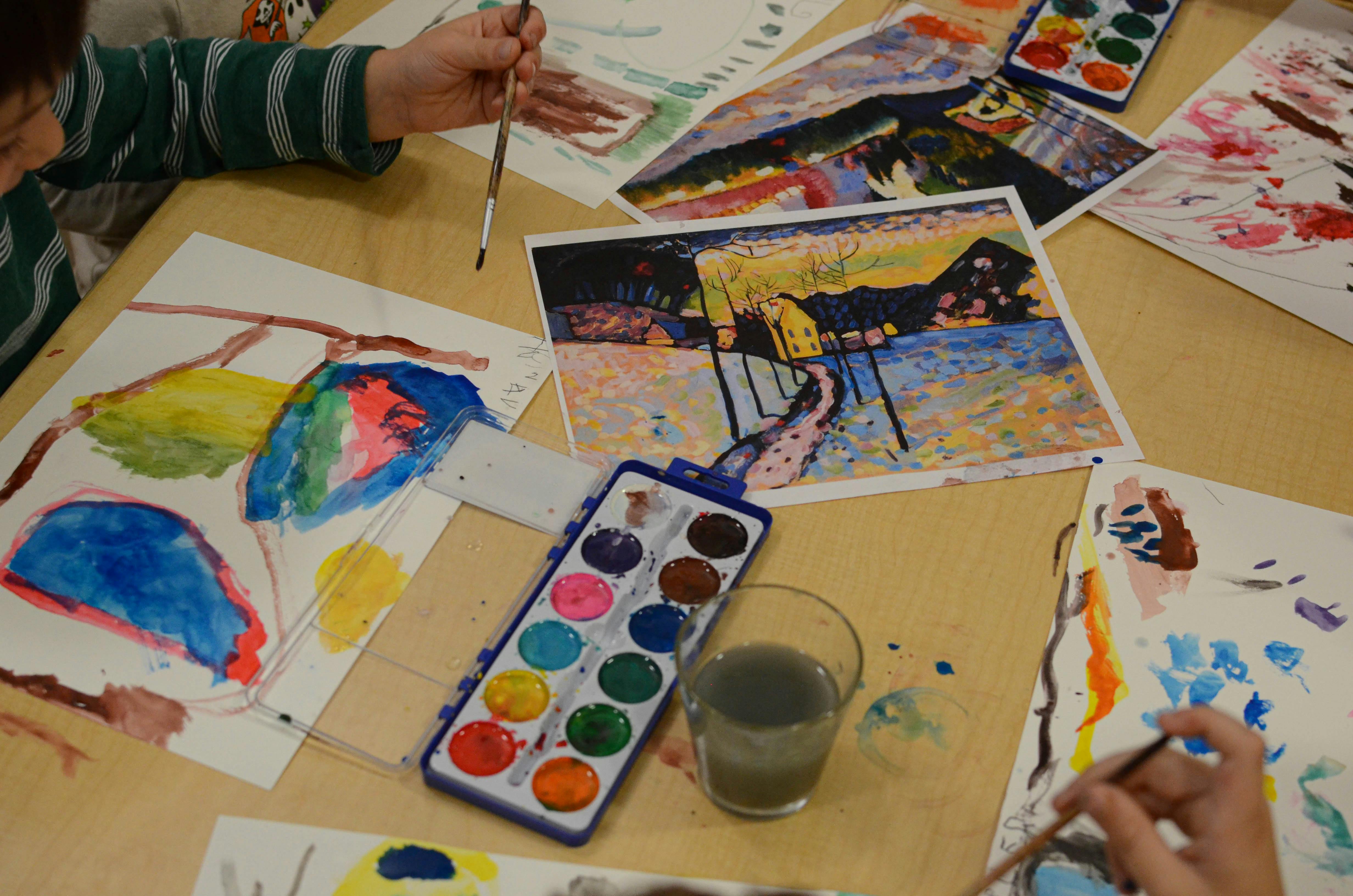 People painting with watercolors at a table